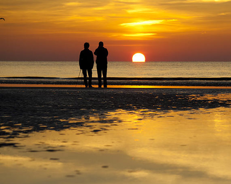 walking along the beach at sunset